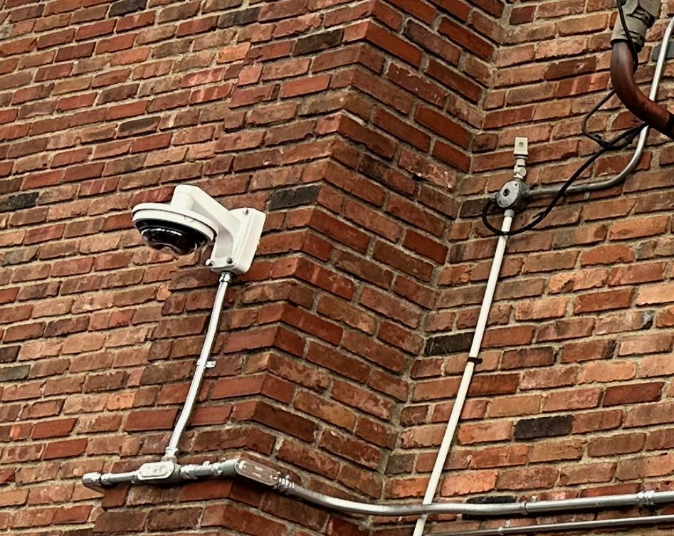 K60 radio with Hanwha dome camera on brick building
